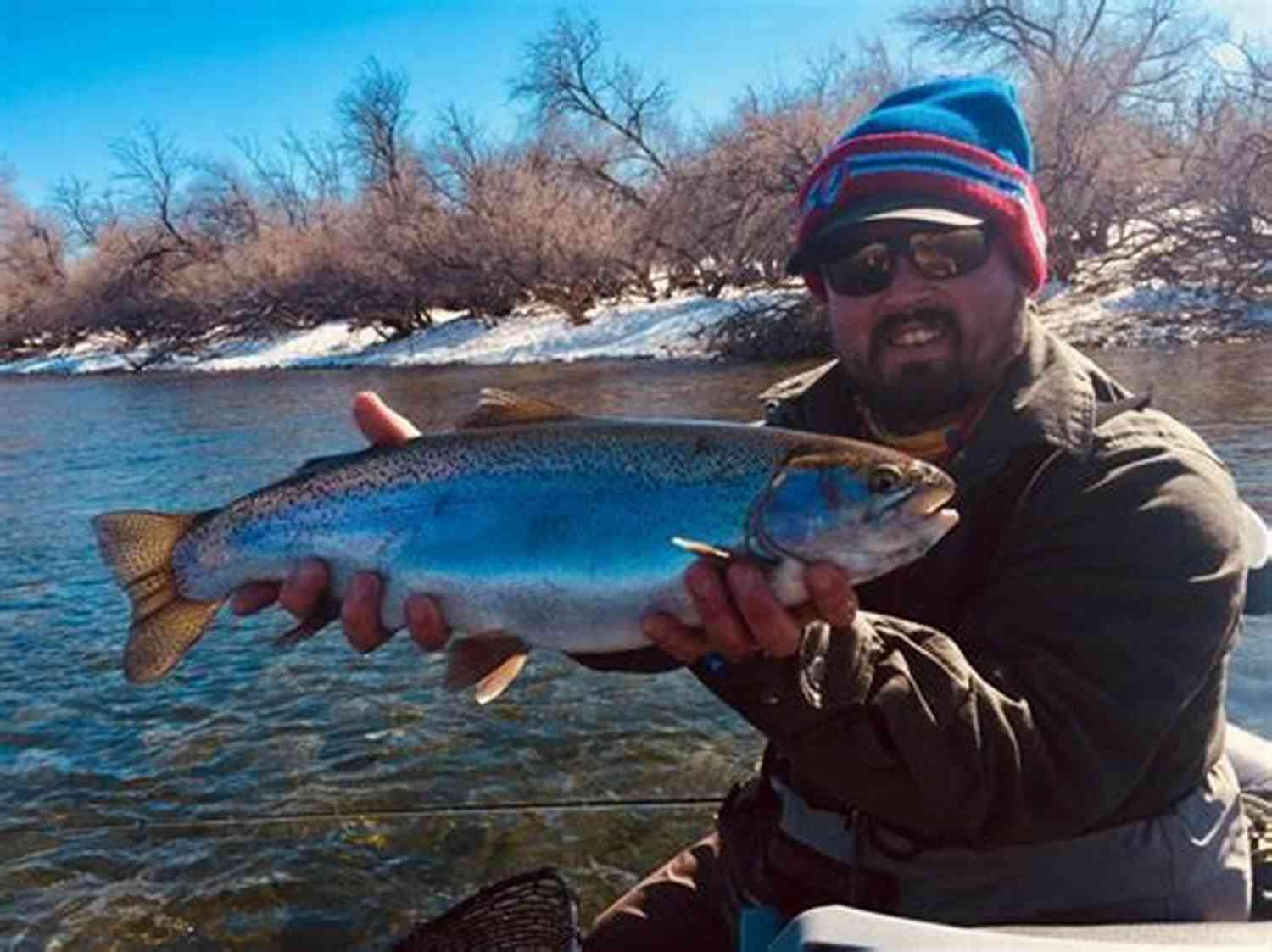 Fly Fishing On The Bighorn River An Angler Casting Their Line Against The Scenic Backdrop Of The Picturesque Bighorn River. Fly Fishing The Bighorn River